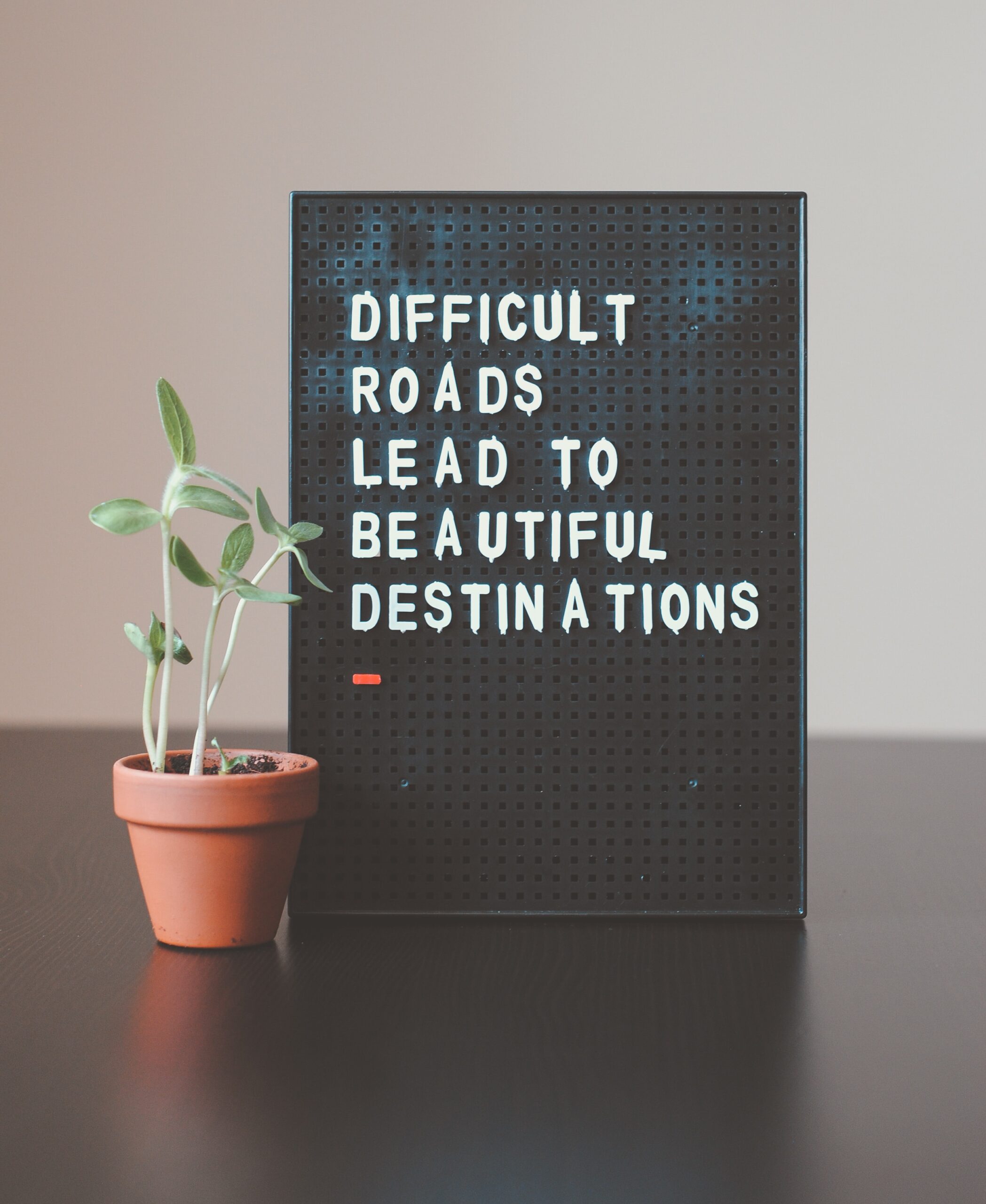 Sign that reads, "Difficult roads lead to beautiful destinations."