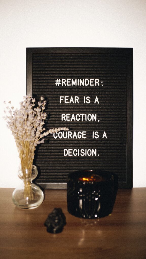sign that reads, "#Remember: Fear is a reaction; courage is a decision."