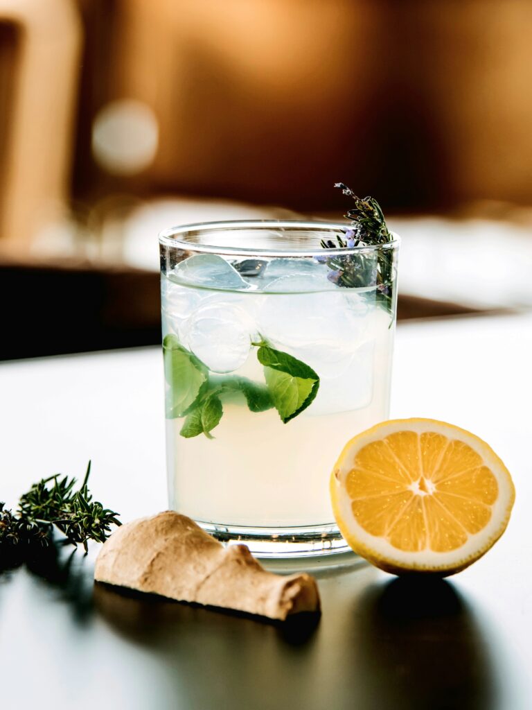 Refreshing glass of water infused with lemon and ginger, a natural way to boost metabolism and add flavor for increased hydration and energy.